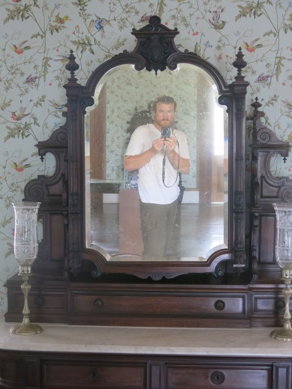 I thought it was cool to look into a mirror in this old Cheatue and capture myself in a mirror that captured the pasts of others because it was the original furniture of the building.